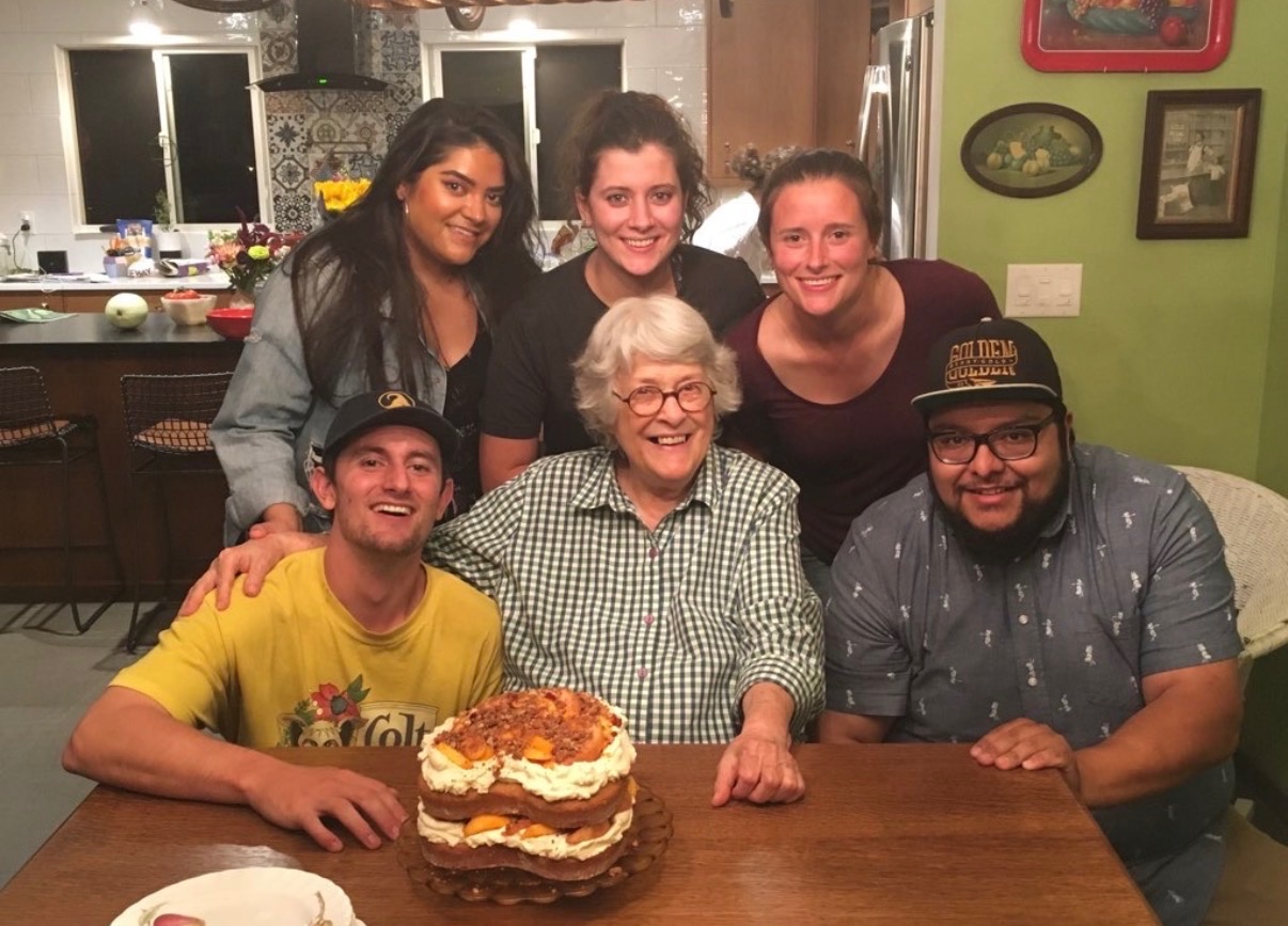 Mam with her grandchildren around a homemade cake